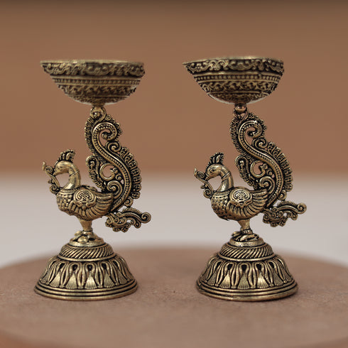 Antique Finish Brass Peacock Diya Pair in 3 Inches Antique Finish Brass Peacock Diya Pair in 3 Inches