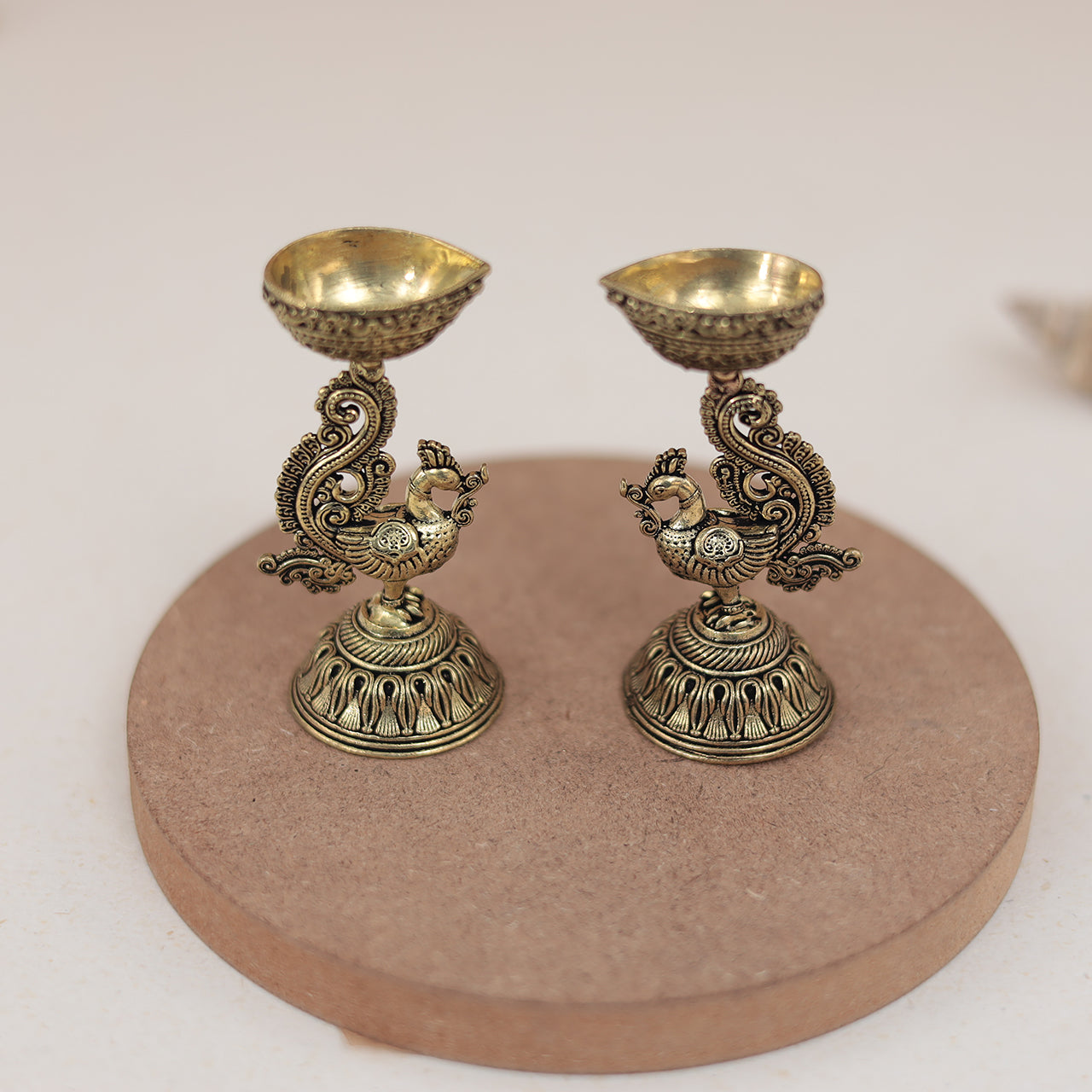 Antique Finish Brass Peacock Diya Pair in 3 Inches Antique Finish Brass Peacock Diya Pair in 3 Inches