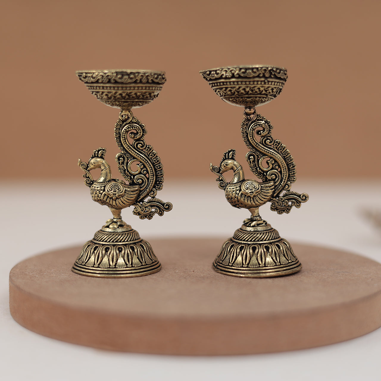 Antique Finish Brass Peacock Diya Pair in 3 Inches Antique Finish Brass Peacock Diya Pair in 3 Inches