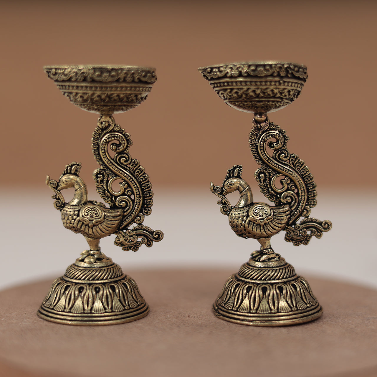 Antique Finish Brass Peacock Diya Pair in 3 Inches Antique Finish Brass Peacock Diya Pair in 3 Inches